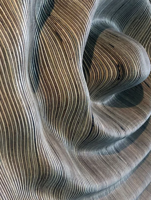 A wooden surface milled into flowing contours