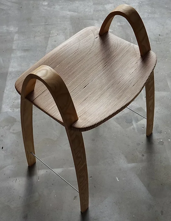 A wooden stool with curved legs