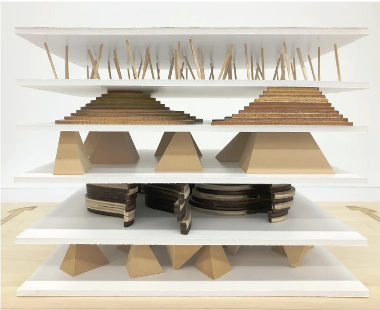 A sectional model of four stacked floors, with vaults at the bottom, tapered timber columns above, and thin sticks at the top