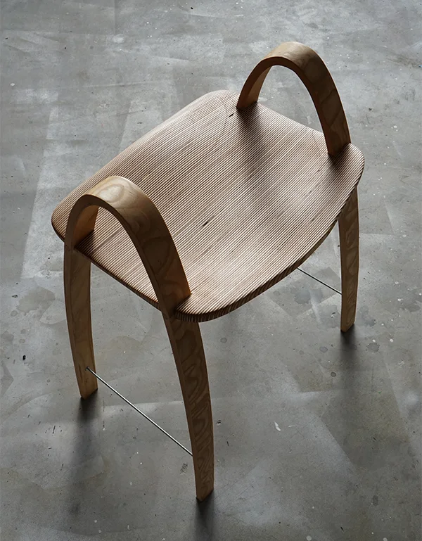 The finished chair from the side on a concrete floor