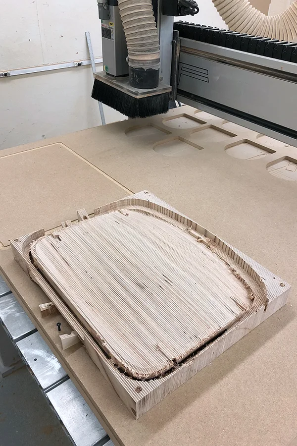 The seat milled to shape, still on the machine bed