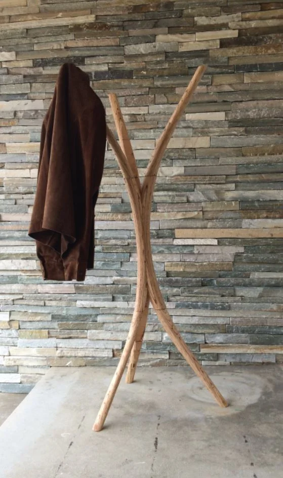 The rack with a dark coat hung on one limb