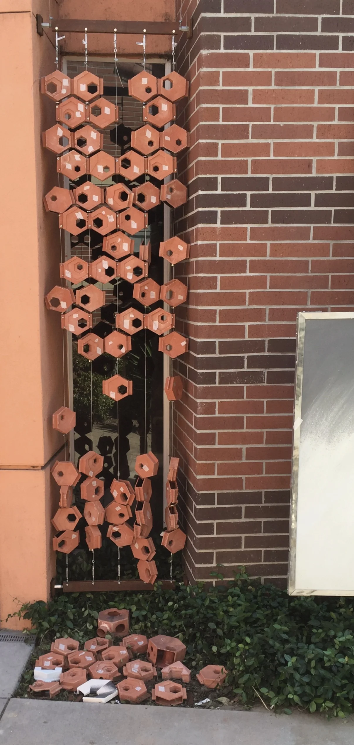 The installation in its corner between two brick walls