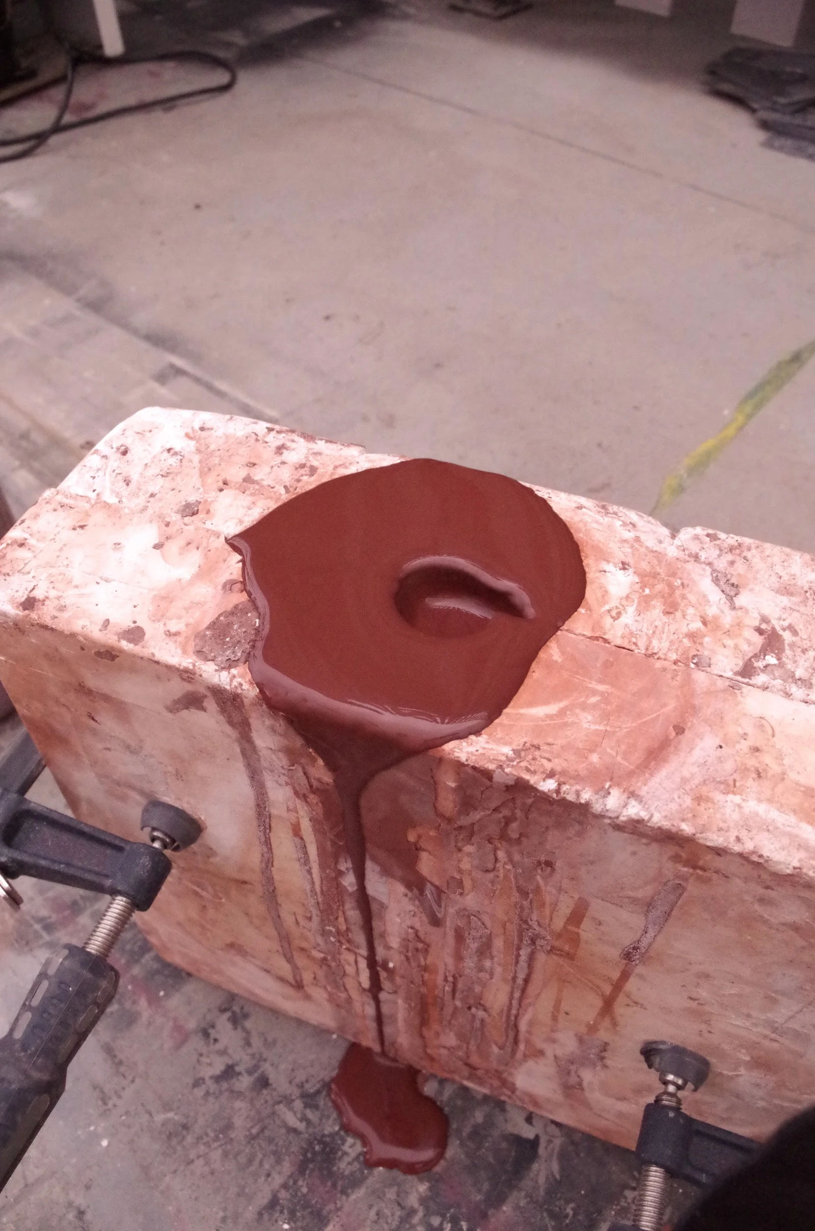 A plaster mold with slip settling in its opening