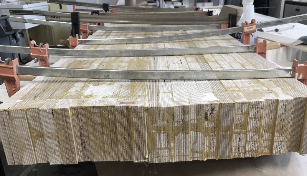 The laminated block, its edge showing dozens of layers